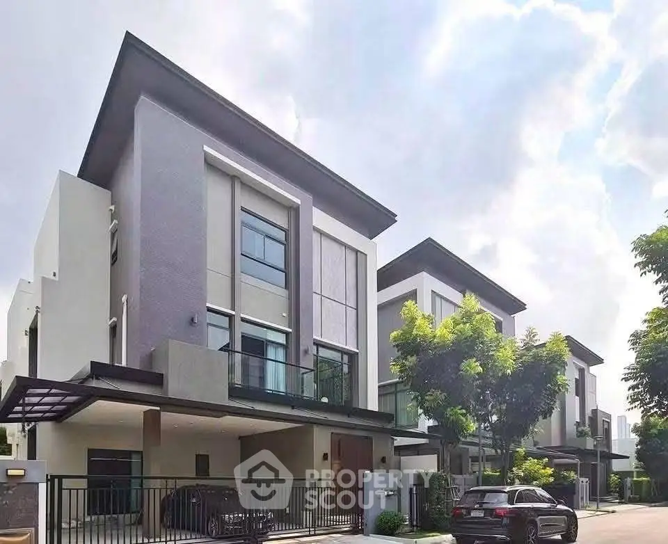 Modern luxury homes with sleek design and spacious driveways in a serene neighborhood.