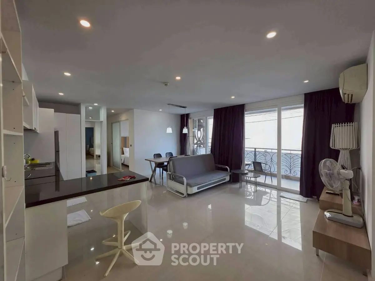 Spacious modern living room with open layout and balcony access