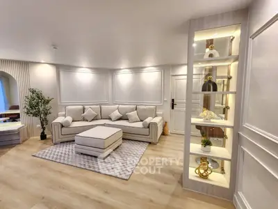 Luxurious living room with elegant decor and plush seating in a modern apartment.
