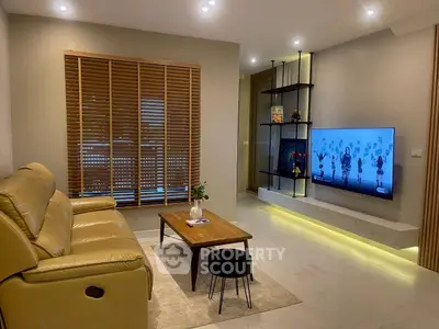 Modern living room with sleek design, featuring a wall-mounted TV, cozy leather sofa, and stylish wooden blinds.