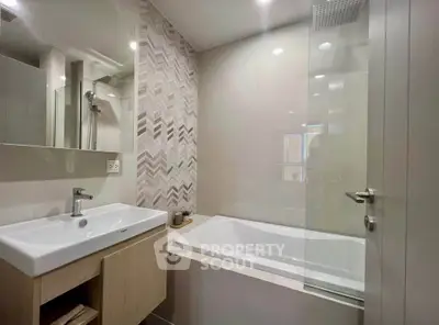 Modern bathroom with stylish tile design and bathtub in contemporary apartment.