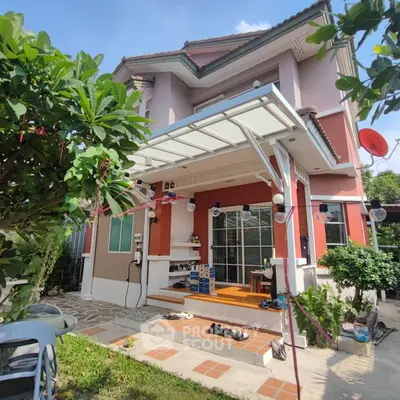 Charming two-story home with a welcoming entrance and lush garden, perfect for family living.