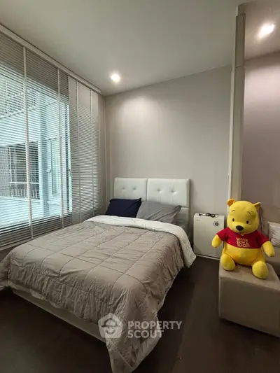 Cozy bedroom with modern decor and plush toy accent