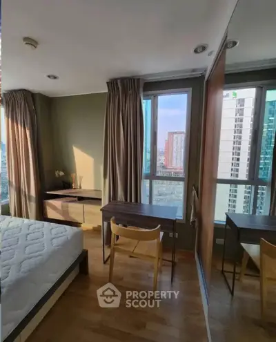 Spacious bedroom with city view and elegant wooden furniture