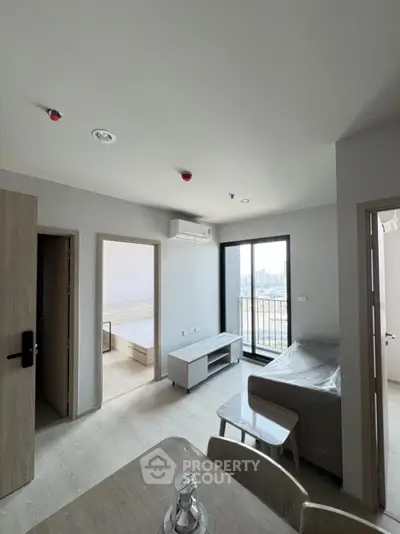 Modern apartment living room with balcony and city view