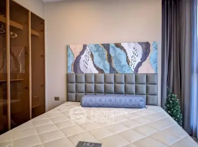 Modern bedroom with stylish decor and large window for natural light.