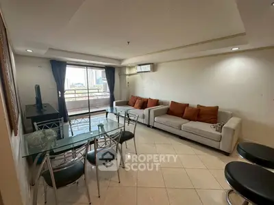 Spacious living room with modern furniture and city view balcony