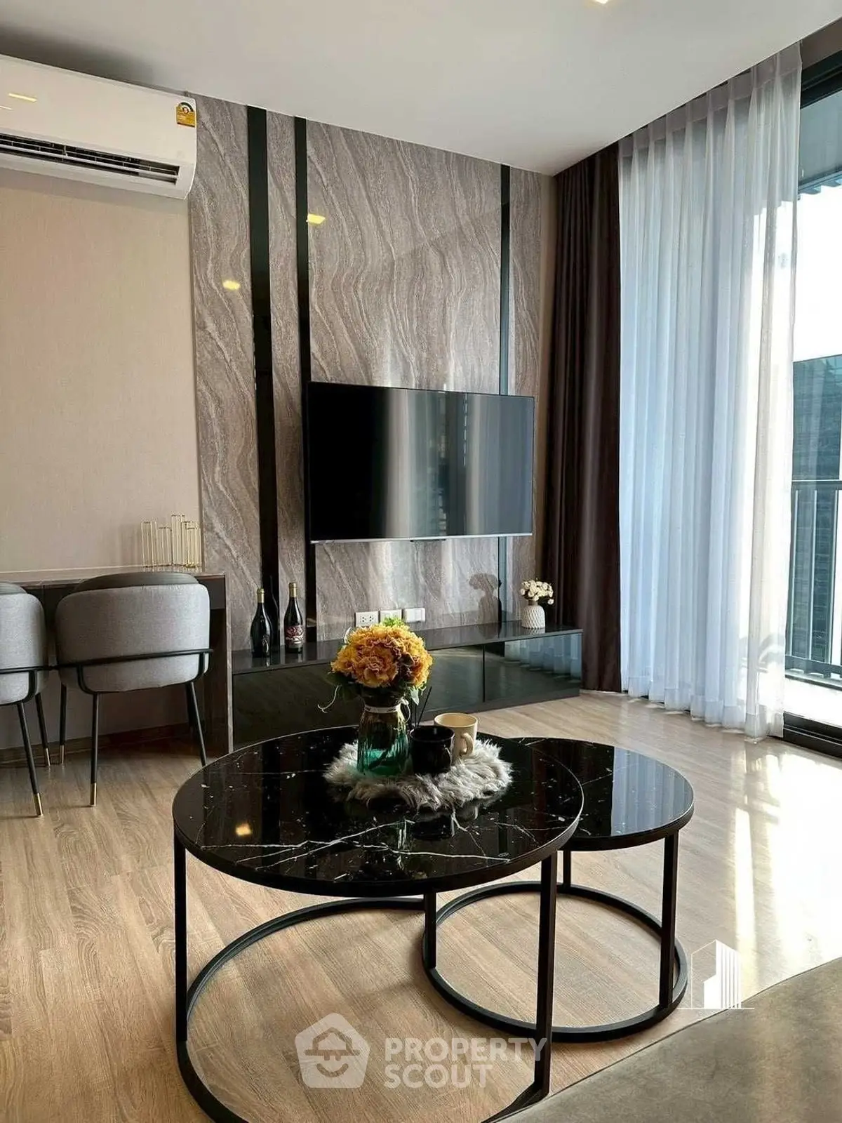 Modern living room with stylish decor and large windows offering natural light