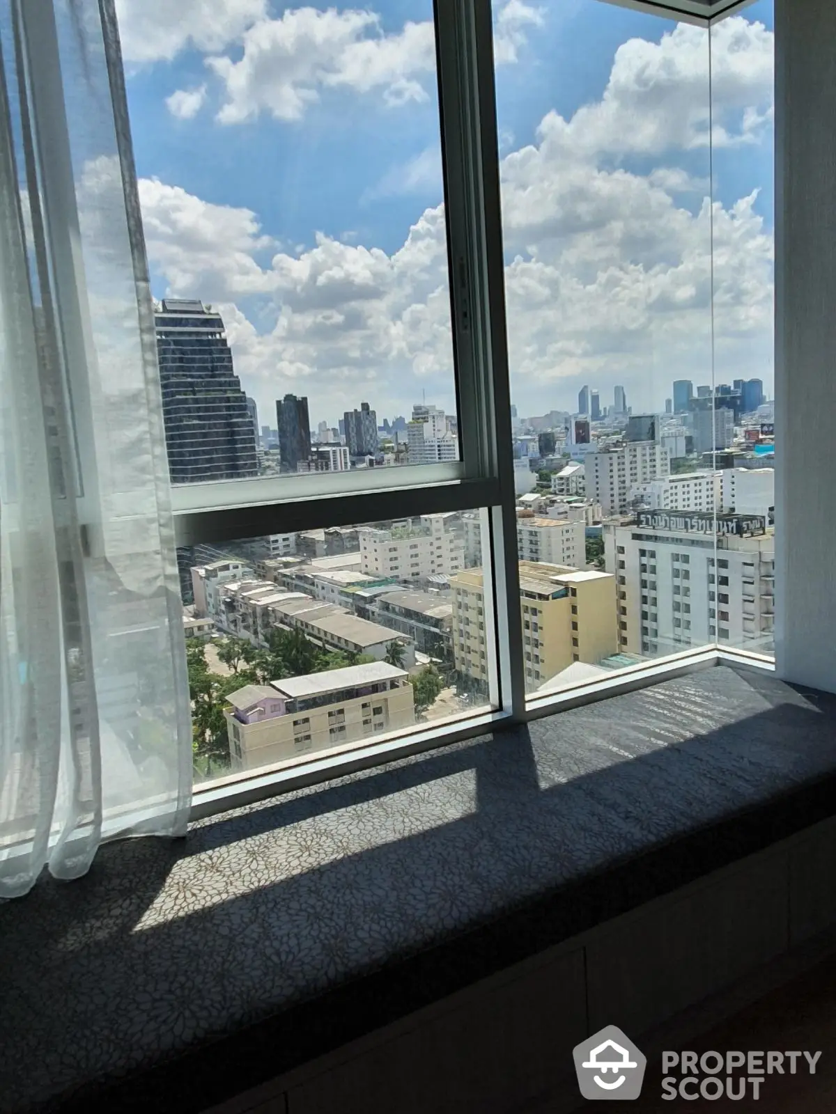 Stunning cityscape view from modern apartment window with natural light