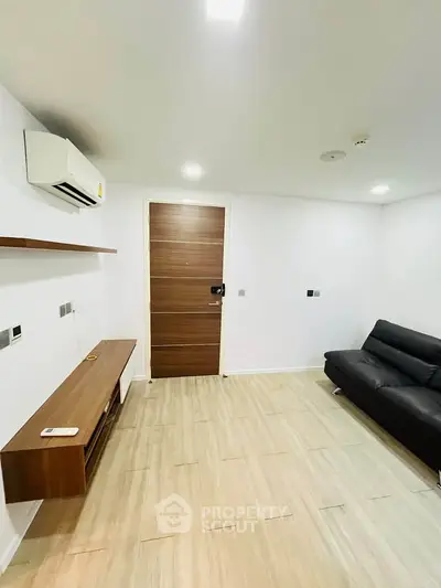 Modern minimalist living room with sleek furniture and air conditioning