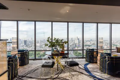 Luxurious high-rise living room with panoramic city views and modern decor.