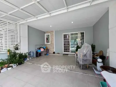 Spacious covered patio with modern design and ample natural light.