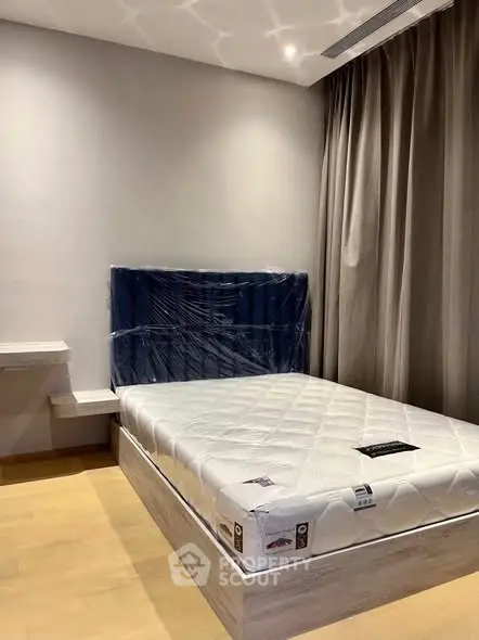 Modern bedroom with new mattress and stylish headboard