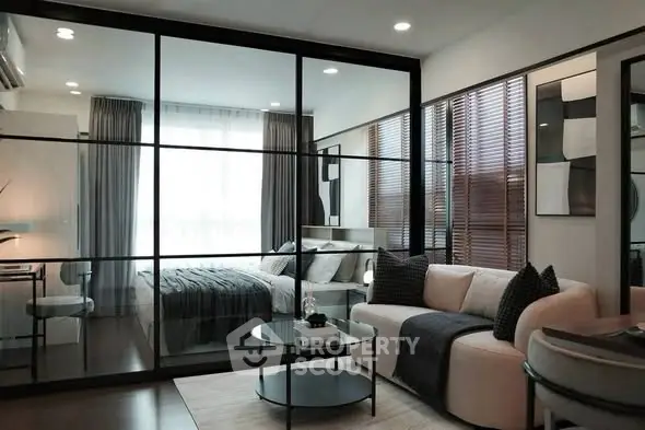 Modern studio apartment with glass partition, cozy living area, and stylish decor.