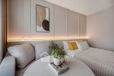 Modern bedroom with cozy sofa and stylish decor, perfect for relaxation and comfort.
