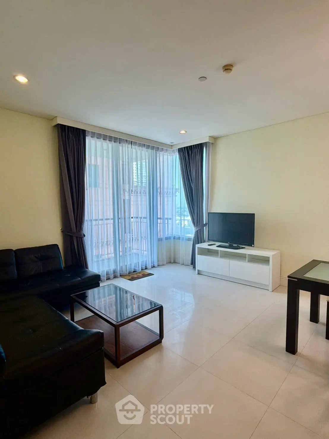 Spacious living room with modern furniture and large windows offering natural light.