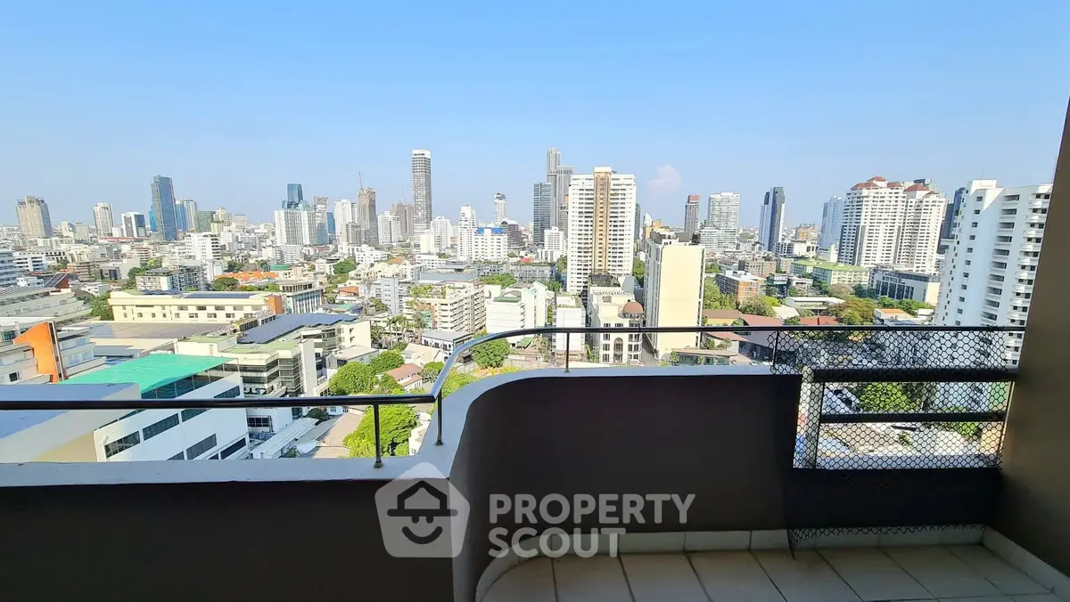 Stunning cityscape view from a high-rise balcony in urban setting.