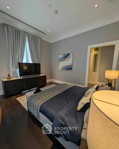 Luxurious bedroom with elegant decor and modern furnishings, featuring a cozy bed and stylish artwork.