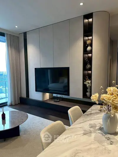 Luxurious modern living room with elegant decor and city view, featuring a sleek TV setup and stylish furnishings.