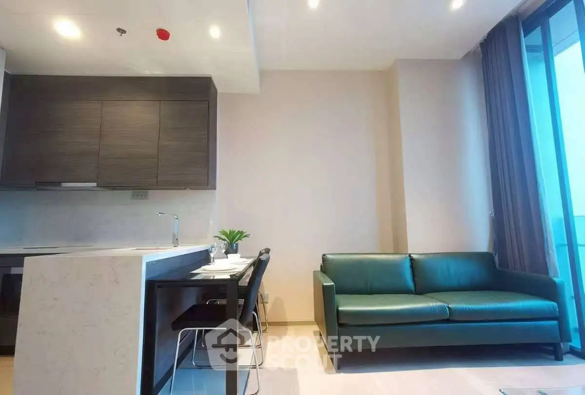 Modern open-layout kitchen and living room with sleek design and natural light.