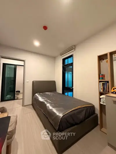 Cozy bedroom with modern furnishings and ample natural light, perfect for restful nights.
