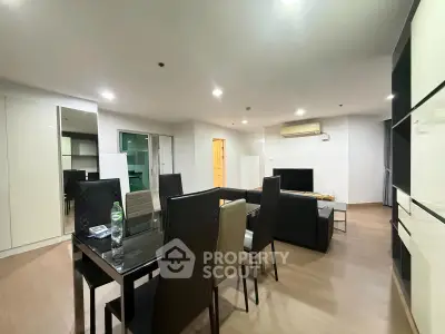 Spacious modern living room with dining area and sleek furniture in a contemporary apartment.