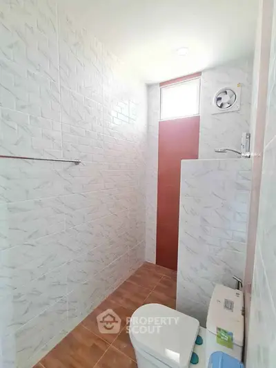 Modern bathroom with tiled walls and natural light