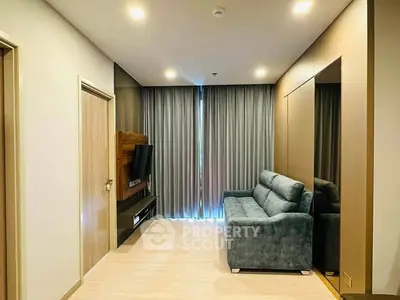 Modern living room with sleek design, featuring a cozy sofa and wall-mounted TV, perfect for relaxation.