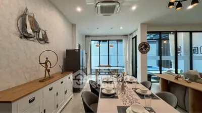 Spacious modern dining and living area with elegant decor and pool view