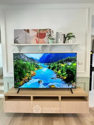 Modern living room with stylish TV stand and vibrant wall art, perfect for contemporary home decor.