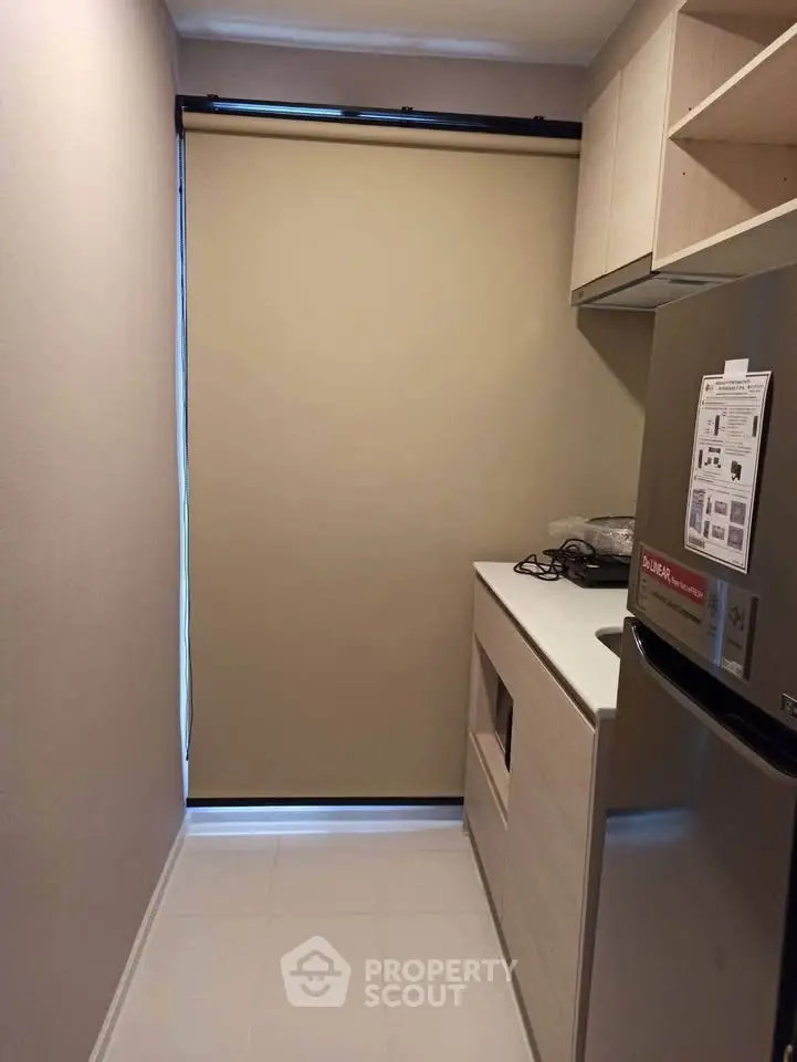 Compact kitchen with modern fridge and closed layout design