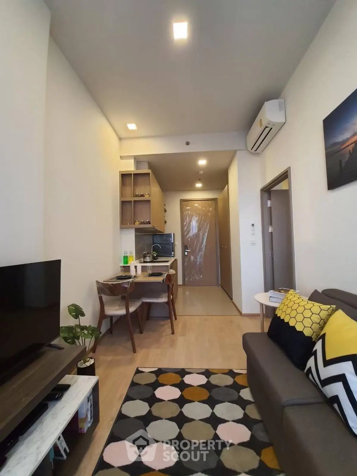 Modern living room with stylish decor and open dining area, featuring cozy seating and contemporary design.