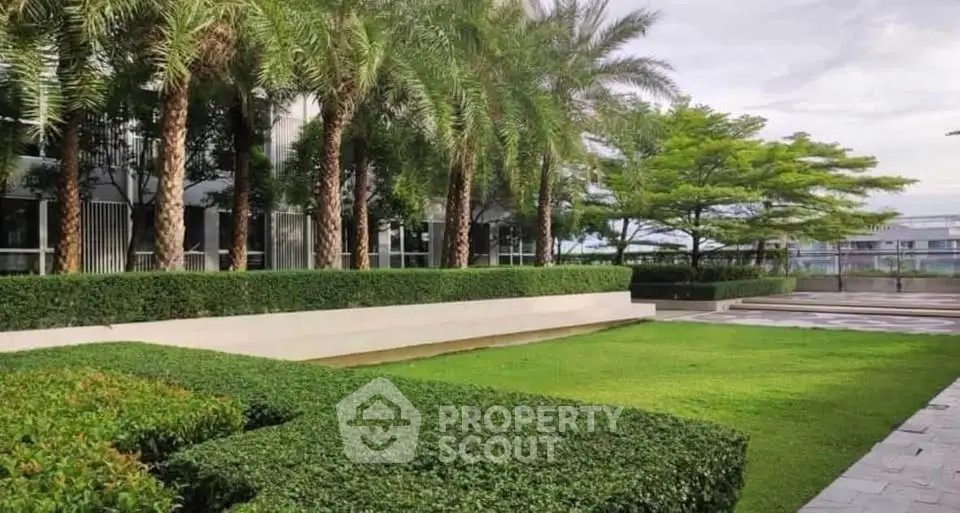 Lush green garden with palm trees in a modern residential complex