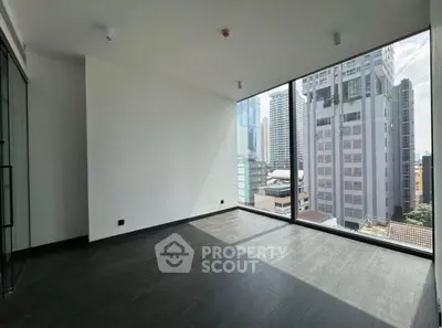 Spacious corner unit with floor-to-ceiling windows offering stunning city views in modern high-rise.
