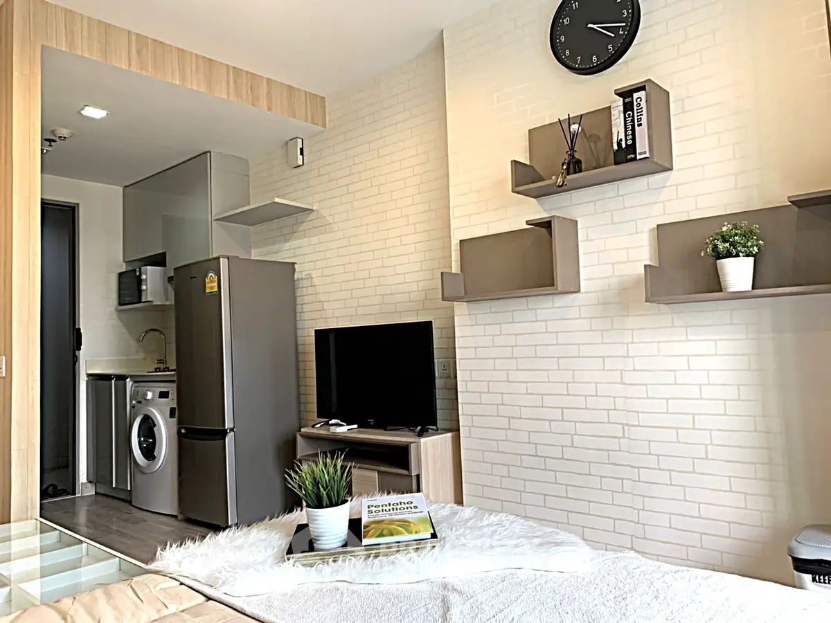 Modern studio apartment with sleek kitchen and cozy living area