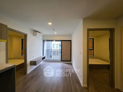 Modern apartment interior with open living space and balcony access