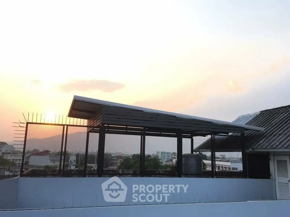 Stunning rooftop view with modern structure and scenic sunset backdrop, perfect for urban living.