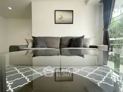Stylish living room with modern decor and large window view.