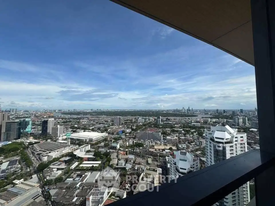 Stunning cityscape view from high-rise balcony showcasing urban skyline and expansive horizon.