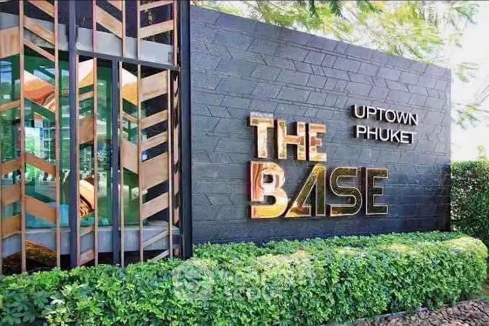 Modern exterior of The Base Uptown Phuket with lush greenery and stylish design.
