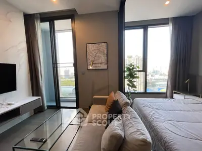 Modern living room with large windows and city view, featuring cozy sofa and stylish decor.