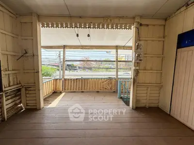 Charming wooden balcony with vintage details and street view, perfect for relaxation.