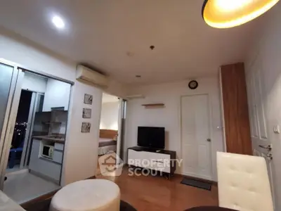 Modern living room with open kitchen and cozy bedroom view