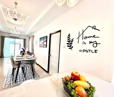 Elegant dining area with modern decor and fruit centerpiece, showcasing a stylish and inviting home interior.