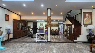 Spacious living room with elegant wooden furniture and marble flooring
