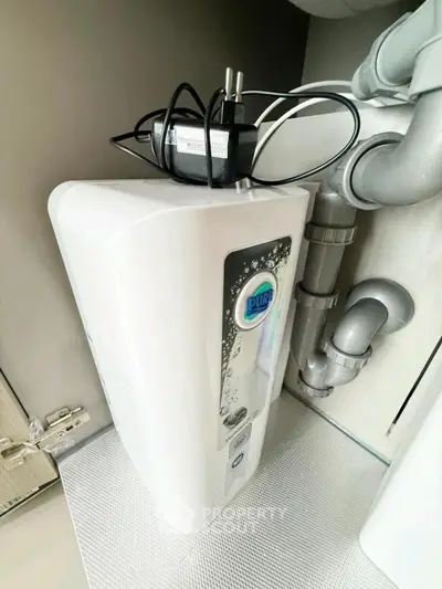 Modern water filtration system installed under kitchen sink