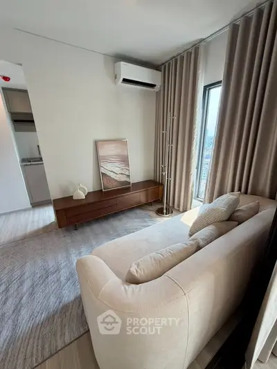 Stylish living room with modern decor and natural light in a contemporary apartment.