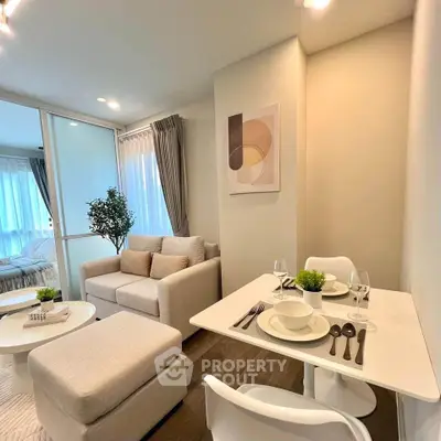 Modern living room with cozy seating and elegant dining area in a bright apartment.