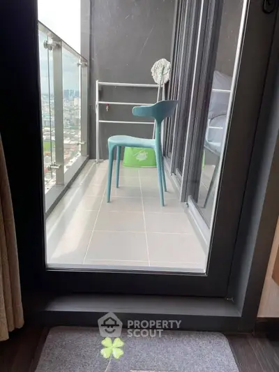 Modern balcony with city view and stylish chair, perfect for relaxation.