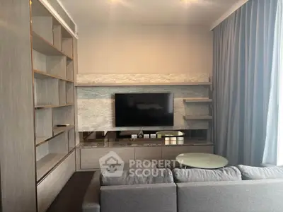 Modern living room with sleek TV setup and stylish shelving